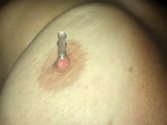 Amateur masochist using pins on her nipples